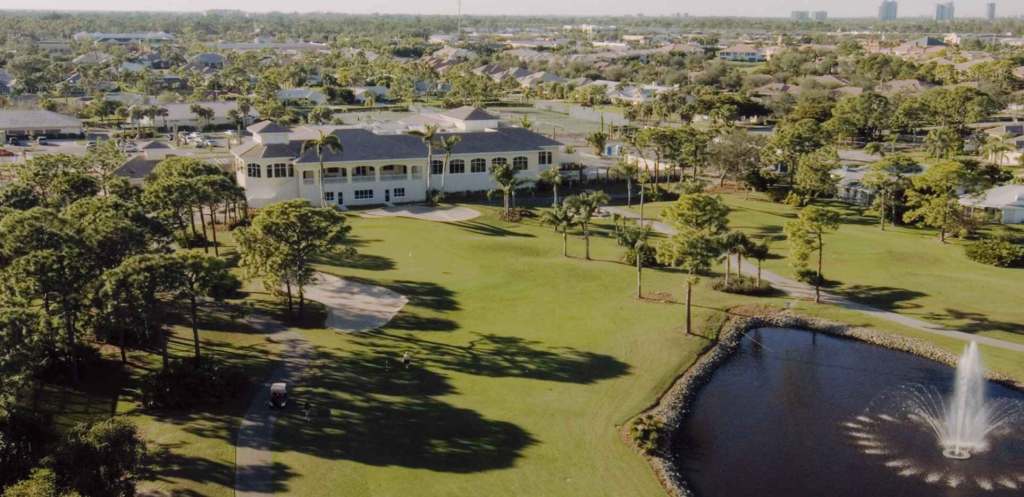 Aerial view of golf course with pond 