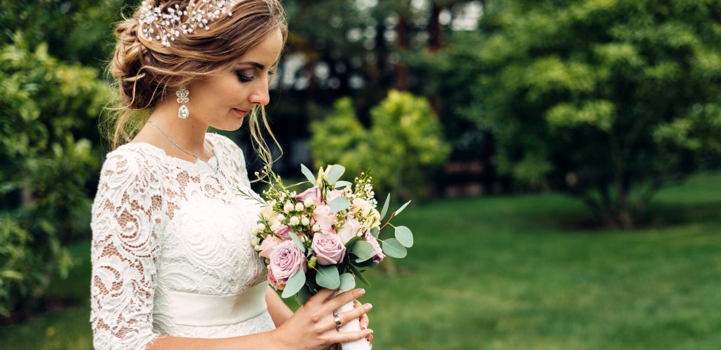 Bride holding bouquet on golf course